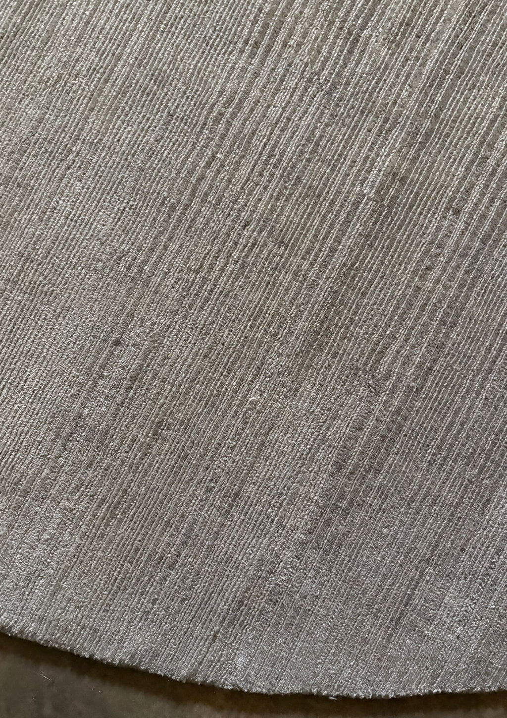 Close-up of a textured handmade luxury gray rug
