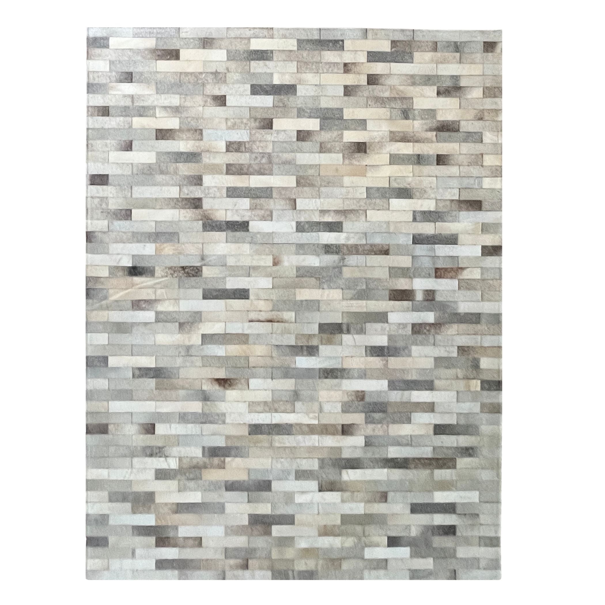 Rectangular rug with a pattern of interlocking rectangular pieces in neutral colors on a white background