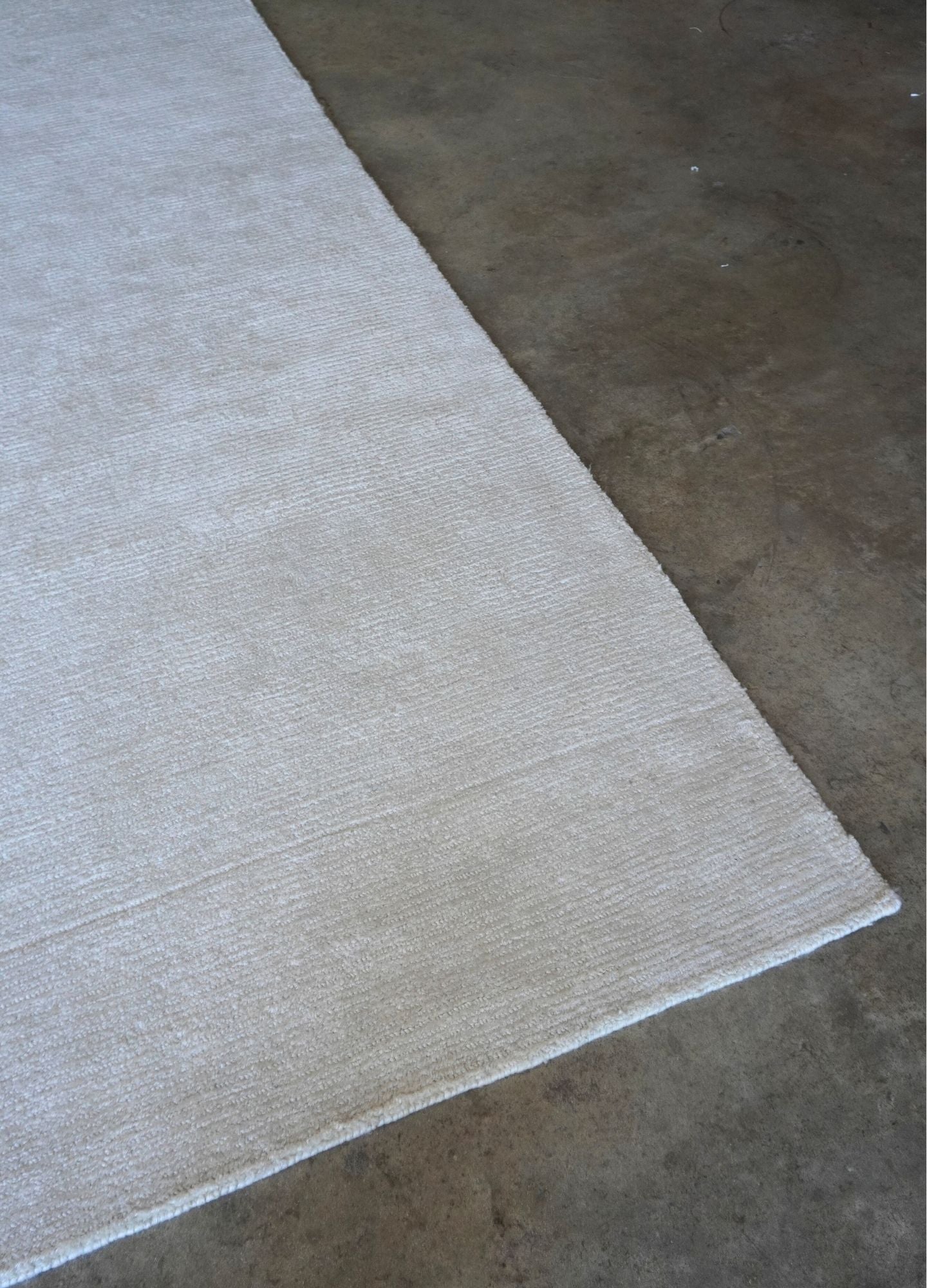 Beige rug on a concrete floor